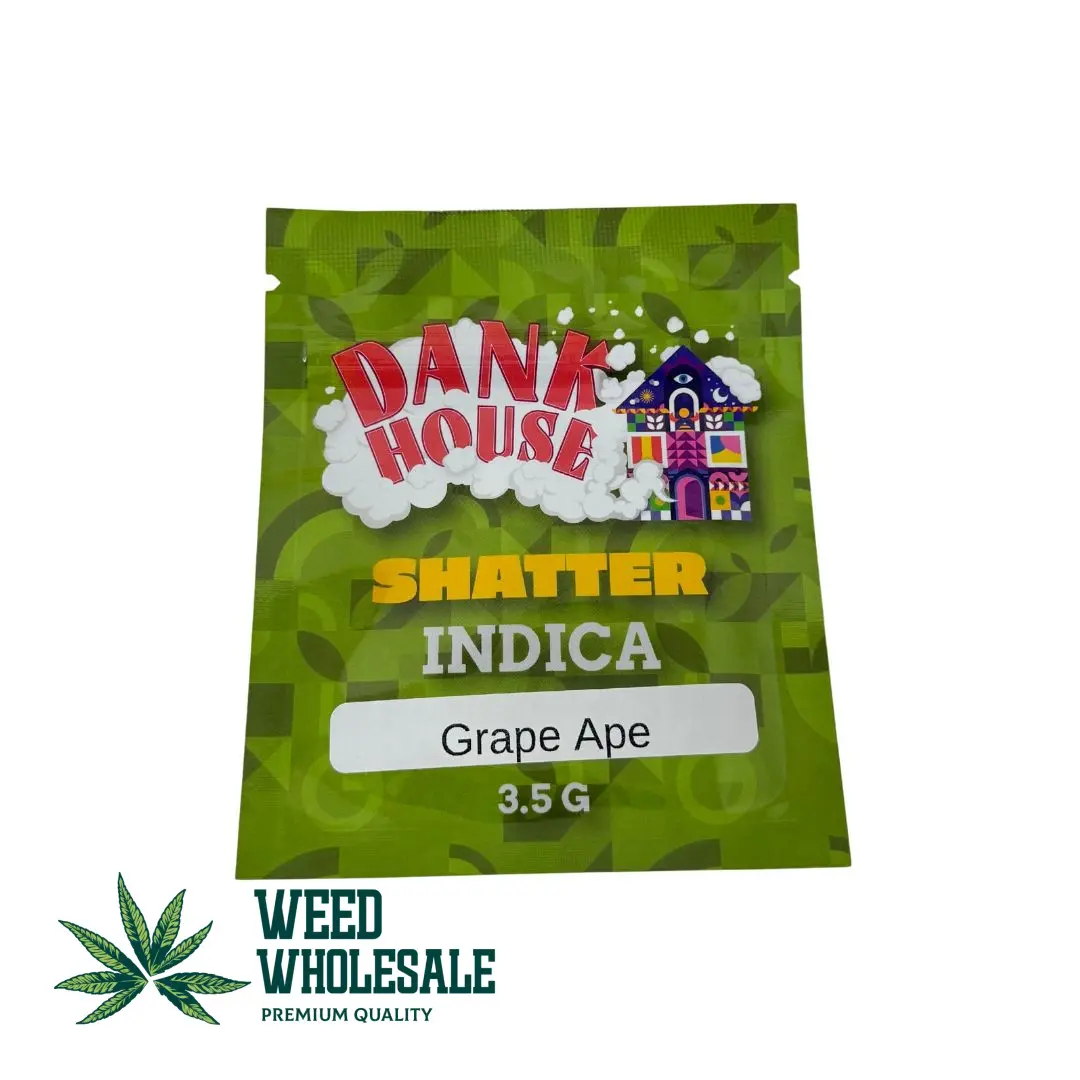 A green packet of Dank House Shatter in 3.5g size indicating it is an indica (Grape Ape) strain.