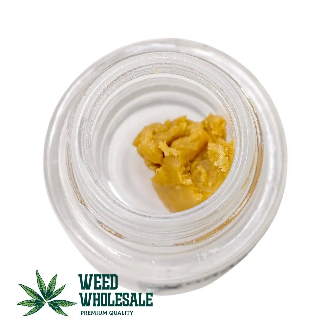 THC Budder cannabis concentrate featuring creamy golden budder consistency in a clear jar.