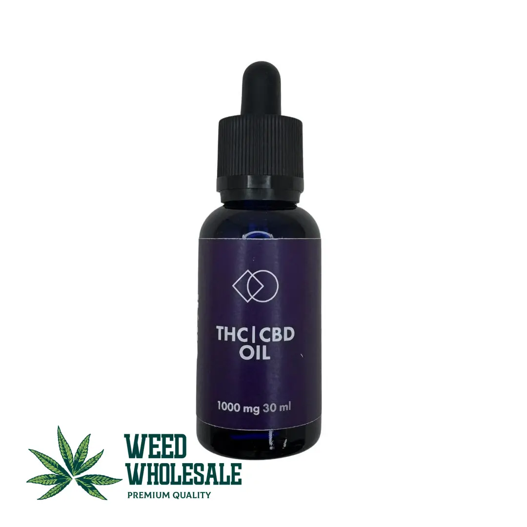 A 30ml bottle of balanced 1:1 THC and CBD oil with a golden cannabis extract and glass dropper.